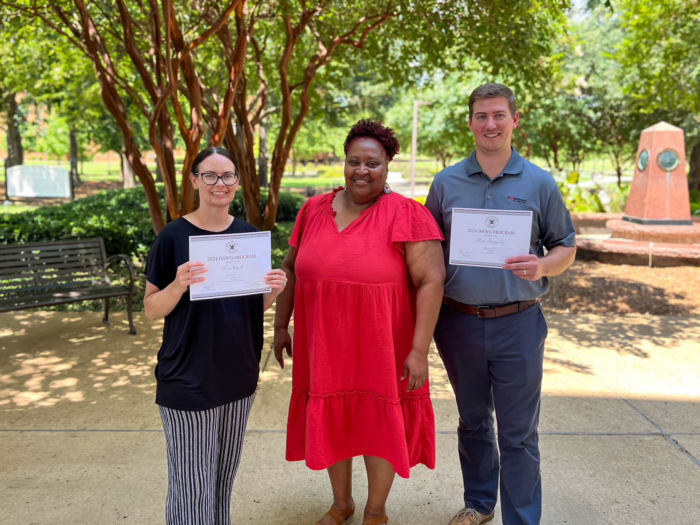 Three MSU staff members pose for a photo